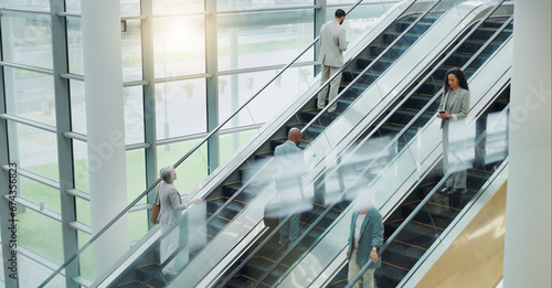Business people, elevator and travel with office and international trip with lens flare. Corporate, professional on escalator and appointment with conference, stairs for convention and executives photo
