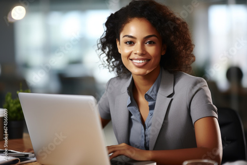 Woman sitting in front of laptop computer. This image can be used to represent remote work, online learning, or technology in everyday life.