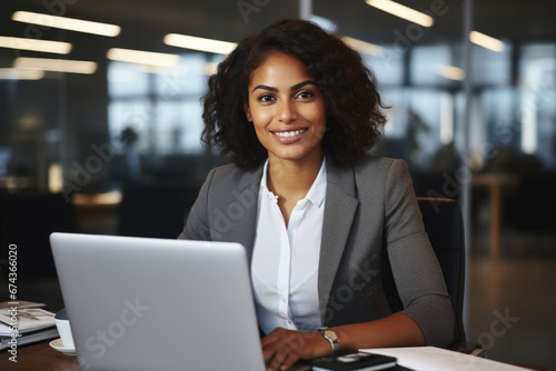 Woman sitting in front of laptop computer. This image can be used to illustrate work, technology, or remote working.