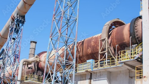 Cement factory. Pipes and compressors, equipment, metalurgy. Modern technologies work at a cement plant. Technological work on the production of cement. Working atmosphere with copy space.