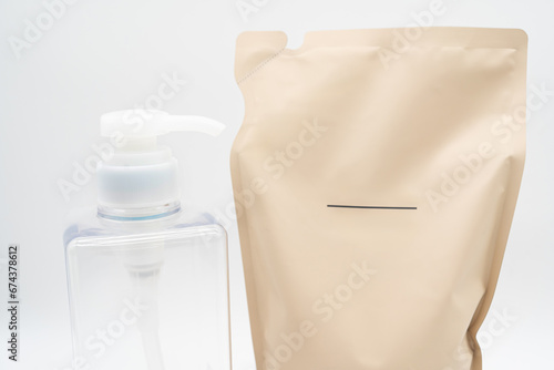 Plastic packaging for refill pouch and Plastic pump bottle in isolated background. Zero waste. Reuse reduce recycle concept. Refillable reusable personalised pump dispenser bottles. photo