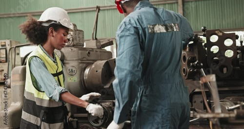 Multi-ethnic engineering team Check mechanical equipment in industrial factory to ensure quality. Technician inspect evaluate maintenance work in construction machine. professional work. Blue collar