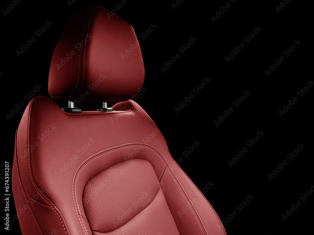 Naklejka premium Car red leather interior. Part of red leather car seat details with white stitching. Interior of prestige car. Perforated leather seats isolated on black. Perforated leather.
