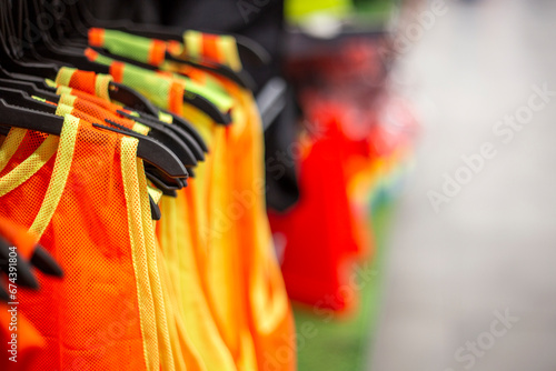 Colorful sportswear for soccer training or shirtfront on hangers in a sports shop. copy space photo
