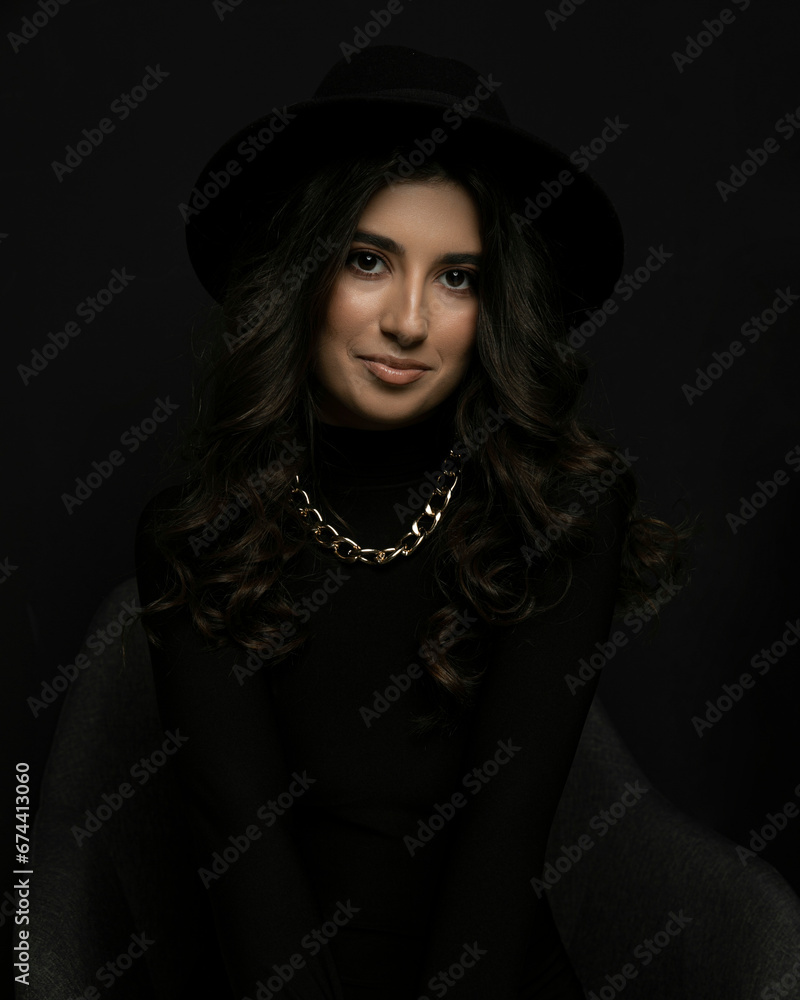Portrait of an attractive female model in black, solated on a black background. Portrait of an attractive female model in black, solated on a black background.