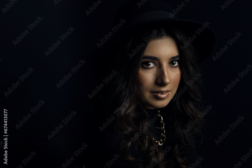 Portrait of an attractive female model in black, solated on a black background. Portrait of an attractive female model in black, solated on a black background.