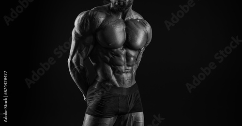 Muscular male torso. Perfect fit, six pack, abs, shoulders, deltoids, biceps, triceps and chest. Black and white image