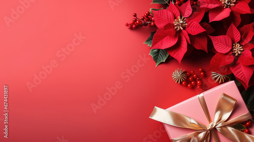 pink christmas background with poinsettia with leaves, red berries, gift box wrapped red silk ribbon, gold tinsel, with empty copy Space