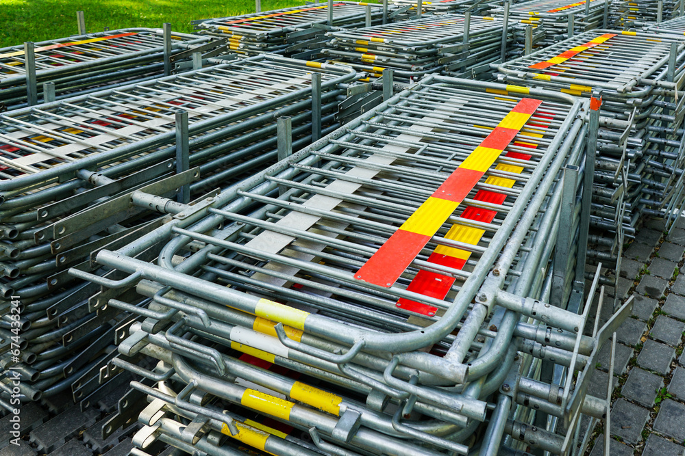 Stacked galvanized metal fences barriers for event organization and crowd control, steel fencing Stacked galvanized metal fences barriers for event organization and crowd control, steel fencing