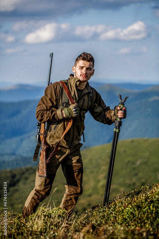 Hunter with hunting gun and hunting form to hunt. Prepare for hunting. Hunting equipment and safety measures. Man with rifle hunting equipment nature background. Man is on the hunt. Hunter man Hunter with hunting gun and hunting form to hunt. Prepare for hunting. Hunting equipment and safety measures. Man with rifle hunting equipment nature background. Man is on the hunt. Hunter man