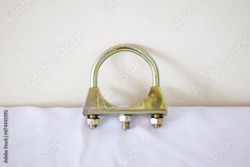 U shape bolt clamp isolated on white, for pipe, glass, or any equipment. Galvanized steel wire rope clips. U shaped bolt used to fix loose end of a loop back to the wire rope or connect two wire rope photo