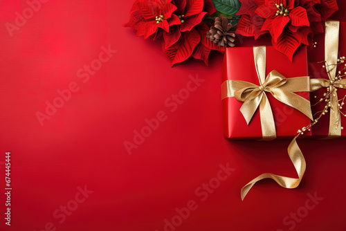 red christmas background with poinsettia with leaves, red berries, gift box wrapped red silk ribbon, gold tinsel, with empty copy Space