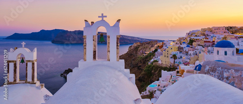 Santorini Greece, White churches and blue domes by the ocean of Oia Santorini Greece, a traditional Greek village in Santorini at sunset