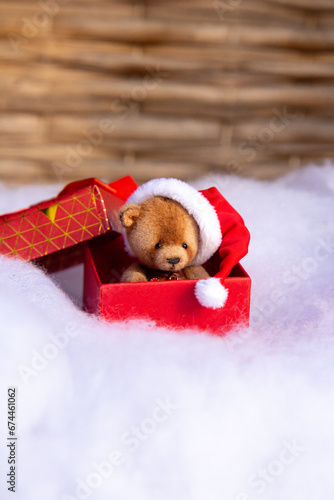 Cute and funny hand made toy bear in gift box on Christmas background