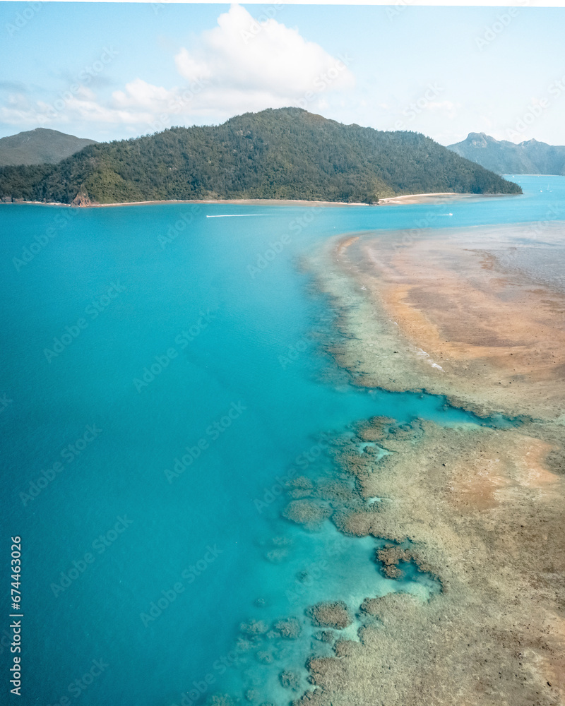 Aerial view of The Great Barrier Reef with clear blue water and Hook Island in the distance, Whitsundays, Queensland Australia. Aerial view of The Great Barrier Reef with clear blue water and Hook Island in the distance, Whitsundays, Queensland Australia.