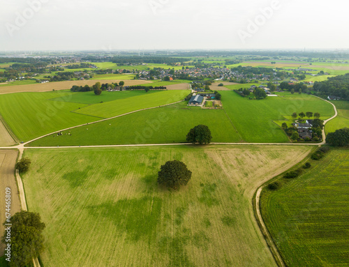 Aerial view of countryside with meadows, cropland and unpaved roads in front of villages Stokkum and 's Heerenberg, Montferland, Gelderland, Netherlands.