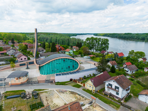 Aerial view of Crkva Gospe od Utocista church along the Danube River in Aljmas small town, Osijek-Baranja, Croatia. photo