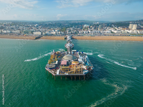 Aerial view of Brighton Palace Pier along the coastline facing the English Channel in Brighton, England, United Kingdom. photo