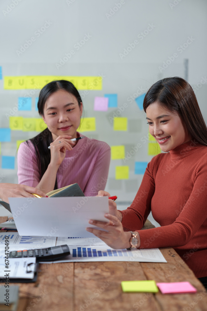 Happy Asian businesswoman working together in office Brainstorming meeting of the online internet technology creative team Business partners or teamwork concept of colleagues in office. Happy Asian businesswoman working together in office Brainstorming meeting of the online internet technology creative team Business partners or teamwork concept of colleagues in office.