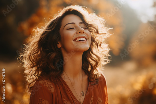 A brunette woman breathes calmly looking up enjoying autumn air