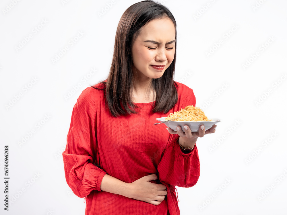 A portrait of a happy Asian woman wearing a red dress, posing hungrily and about to eat noodles. Isolated against a white background. A portrait of a happy Asian woman wearing a red dress, posing hungrily and about to eat noodles. Isolated against a white background.