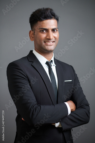 Portrait of confident smiling entrepreneur standing with arms crossed