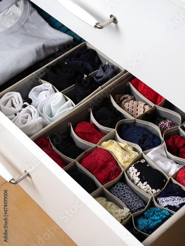 Socks, underwear and shorts folded into an organizer. storage of clothes in a chest of drawers. Organization of storage. Quarantine, self-isolation, housework. Storage systems for clothes