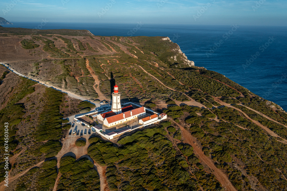 Sunset view of lighthouse and cliffs and sea of cape Espichel