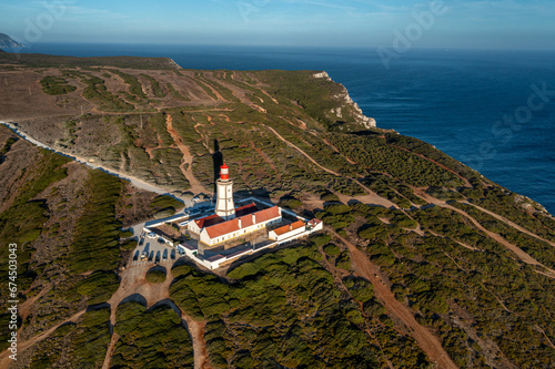 Sunset view of lighthouse and cliffs and sea of cape Espichel