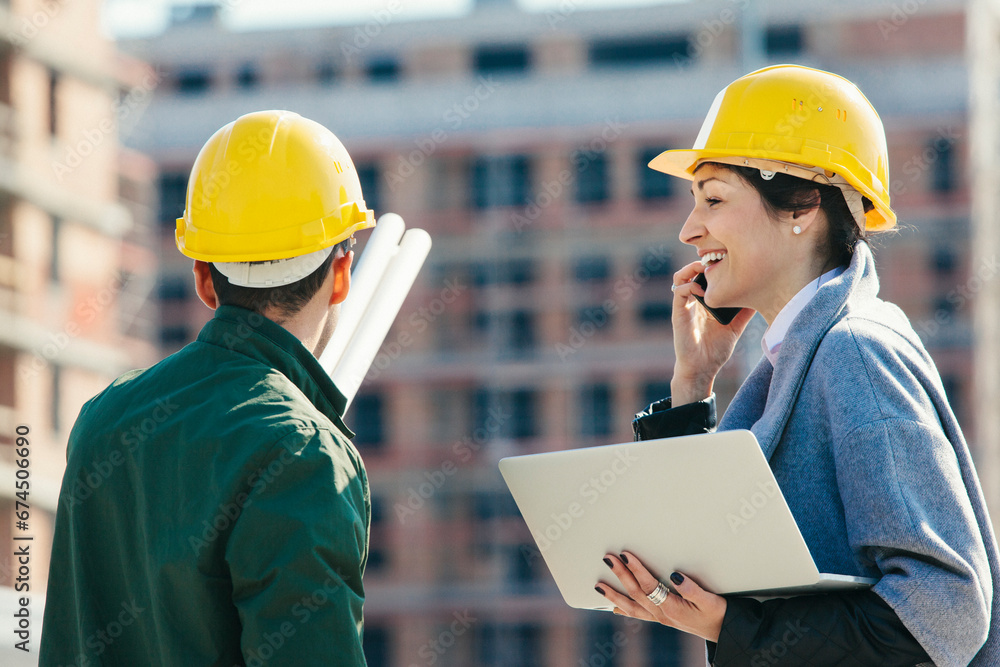 Young engineers consulting at construction site Young engineers consulting at construction site