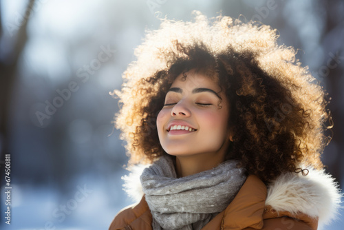 A African woman breathes calmly looking up enjoying winter season