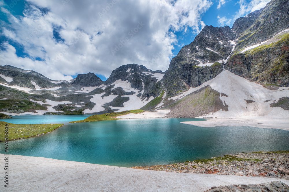 A beautiful alpine lake surrounded by mountains and glaciers.