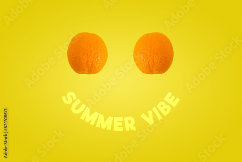 Creative summer layout made of two oranges and SUMMER VIBE text on gradient yellow background.  Fruit minimal concept. Copy space. Smile, positive energy.