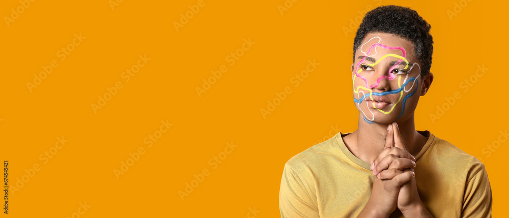 Creative portrait of handsome African-American guy on orange background with space for text Creative portrait of handsome African-American guy on orange background with space for text