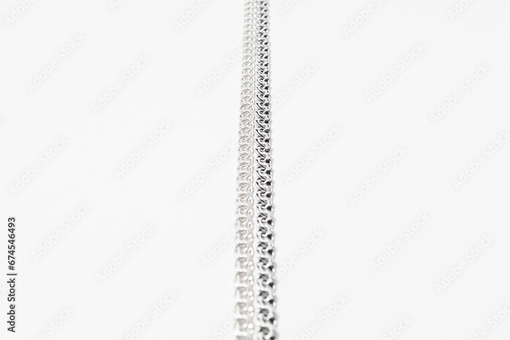 Subject photography of silver chains on a white background