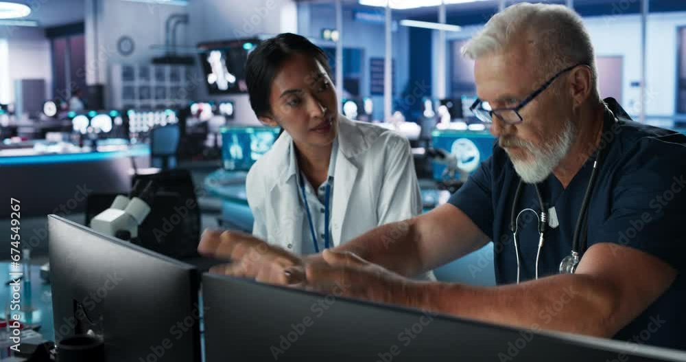 Asian Female Scientist Using Desktop Computer And Talking To Caucasian Male Doctor In Medical Hospital Research Laboratory. Colleagues Discussing Test Results Of Patient, Treatment Methods, Medication