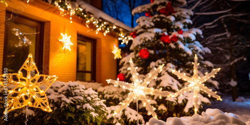 Close-up House decorated with glowing lights for winter holidays. Christmas illumination. Night scene with fresh snow. Christmas and New Year holiday background.	