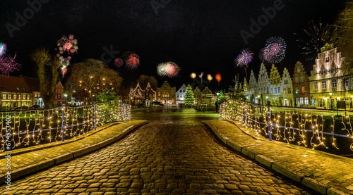 Canvas Print Charming town bathed in festive lighting and fireworks, creating a romantic atmosphere for New Year's Eve with the spectacular display of colors and lights