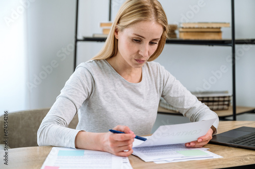 Focused woman lookingat official documents or contract photo