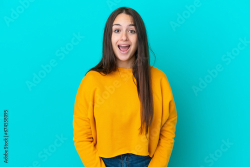Young Ukrainian woman isolated on blue background with surprise facial expression