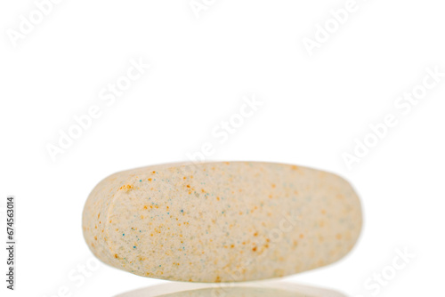One medical pill, macro, isolated on white background.