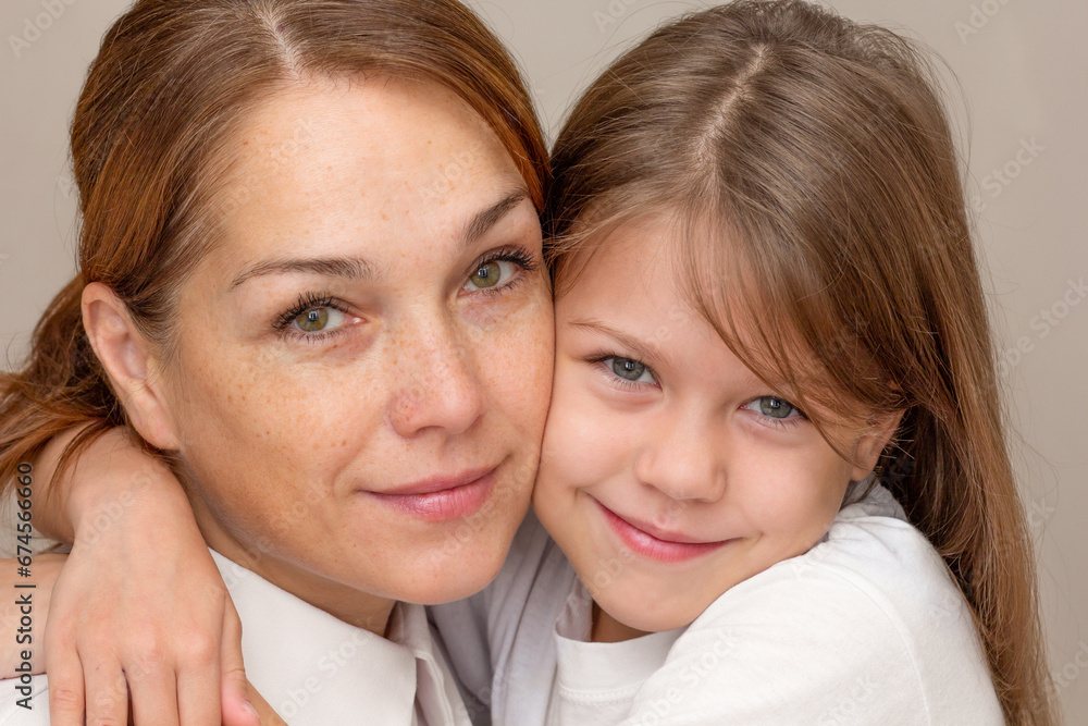 Portrait of mother and daughter hugging Portrait of mother and daughter hugging