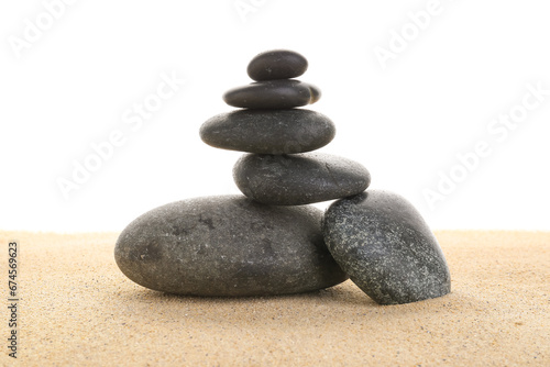 Stack of zen stones on the sand isolated on white background.