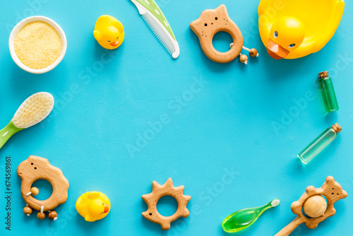 Frame of baby bath products flat lay with rubber duckling and toys