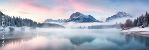 Panoramic view of beautiful lake at sunrise with foggy Winter forest mountain covered by heavy snow and ice. Winter seasonal concept.