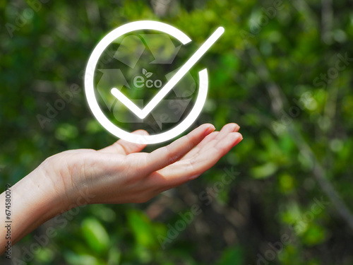 Check mark ECO Recycling reduces global warming. Using renewable energy On the background, the green forest is blurry.