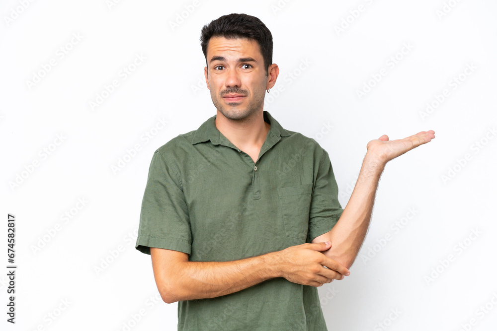 Young handsome man over isolated white background having doubts Young handsome man over isolated white background having doubts