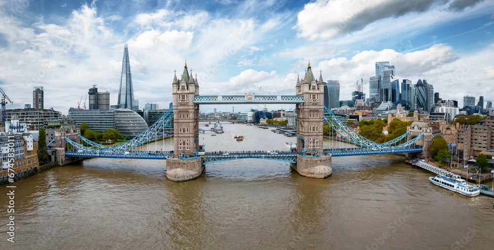 Aerial front view of the Tower Bridge with River Thames and London skyline during a cloudy day