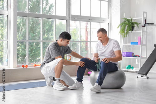 Mature man training on fitb...