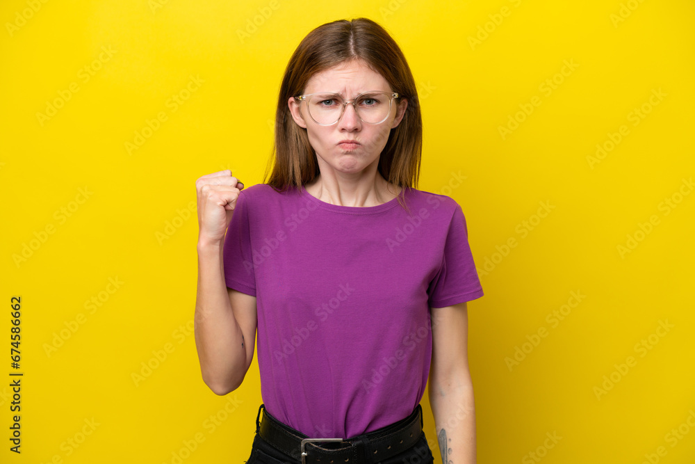 Young English woman isolated on yellow background with unhappy expression Young English woman isolated on yellow background with unhappy expression